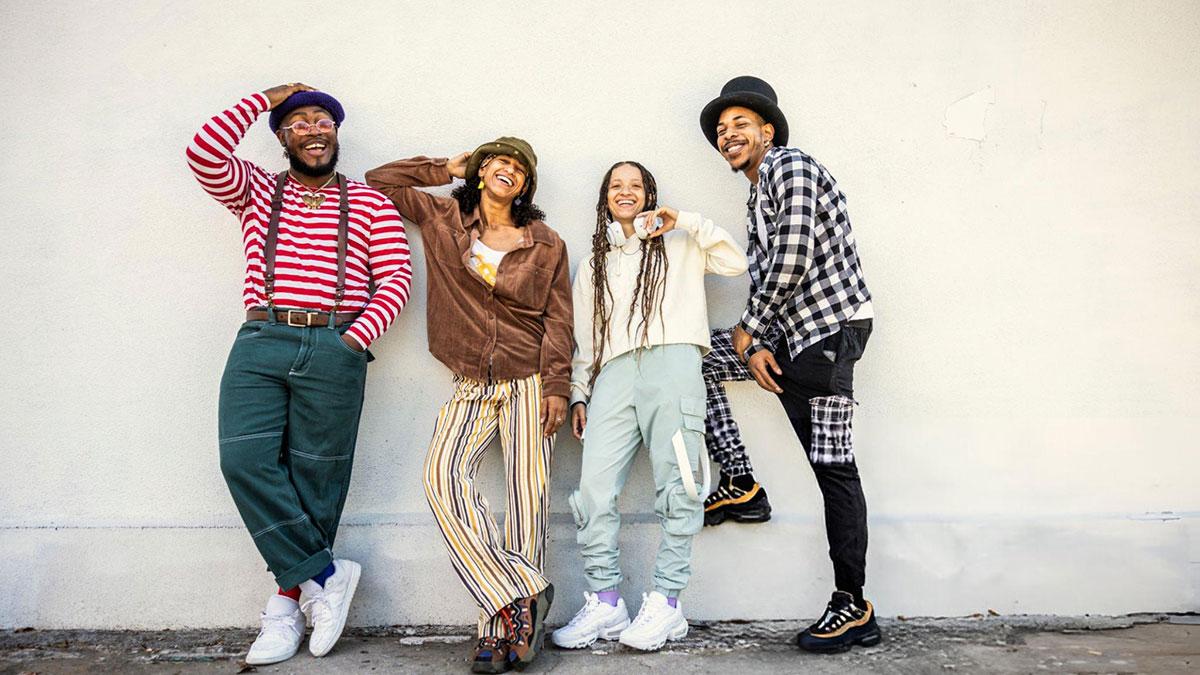 Youth wearing 2025 streetwear fashion including oversized clothes and statement sneakers on a city street